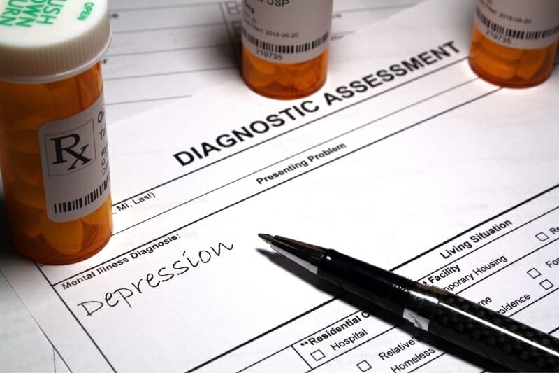 Diagnostic assessment paper identifying depression as the illness with prescription bottles
