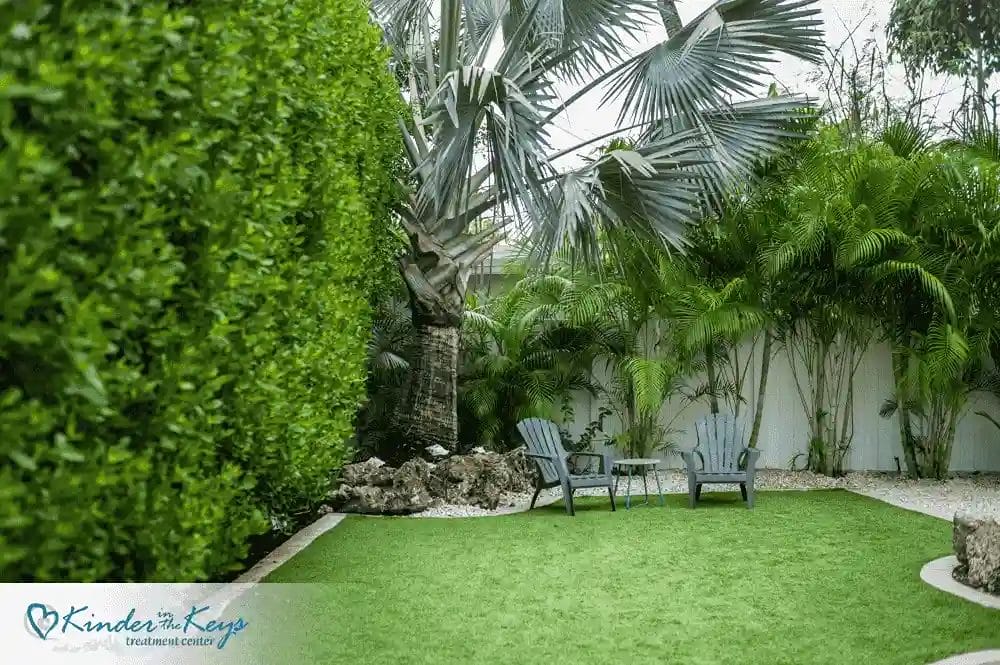 peaceful-garden-setting-with-chairs-and-greenery