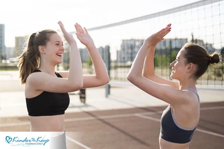 Women playing volleyball outdoors as part of holistic treatment for depression recovery.