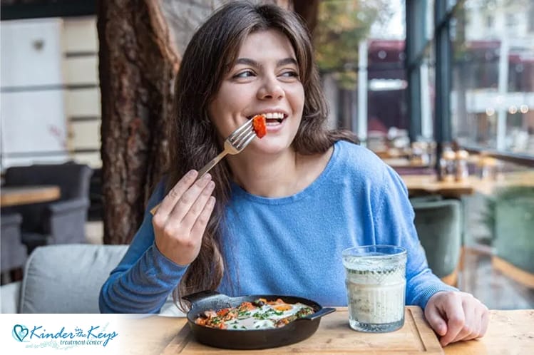 Woman enjoying a healthy meal, showing positive nutrition support for anxiety.
